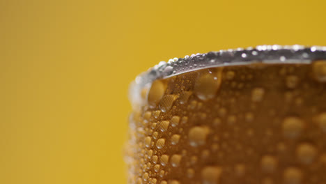 Close-Up-Of-Condensation-Droplets-On-Revolving-Takeaway-Can-Of-Cold-Beer-Or-Soft-Drink-Against-Yellow-Background-With-Copy-Space-1